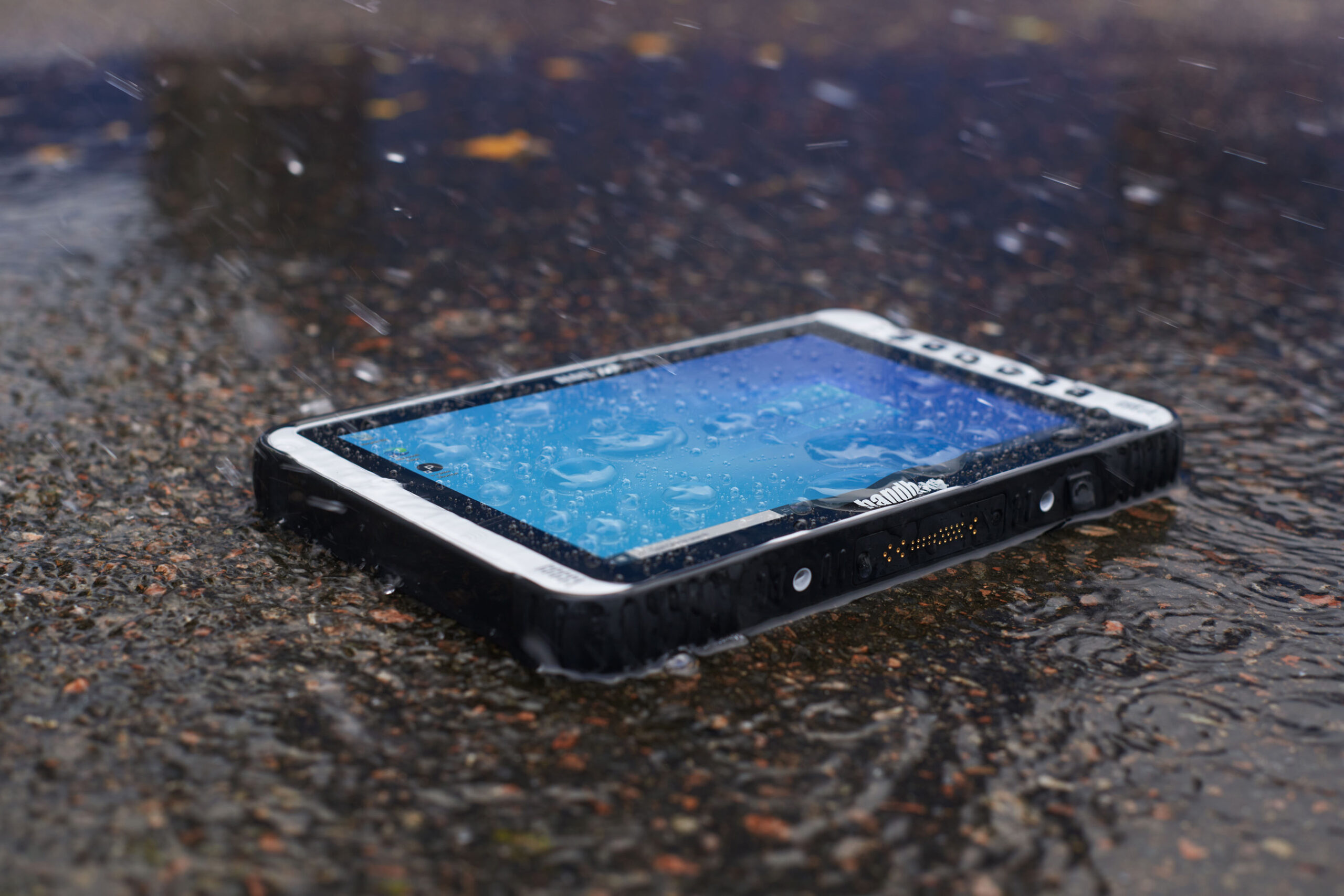 Algiz 10XR rugged Windows tablet on the floor with rain pouring on it