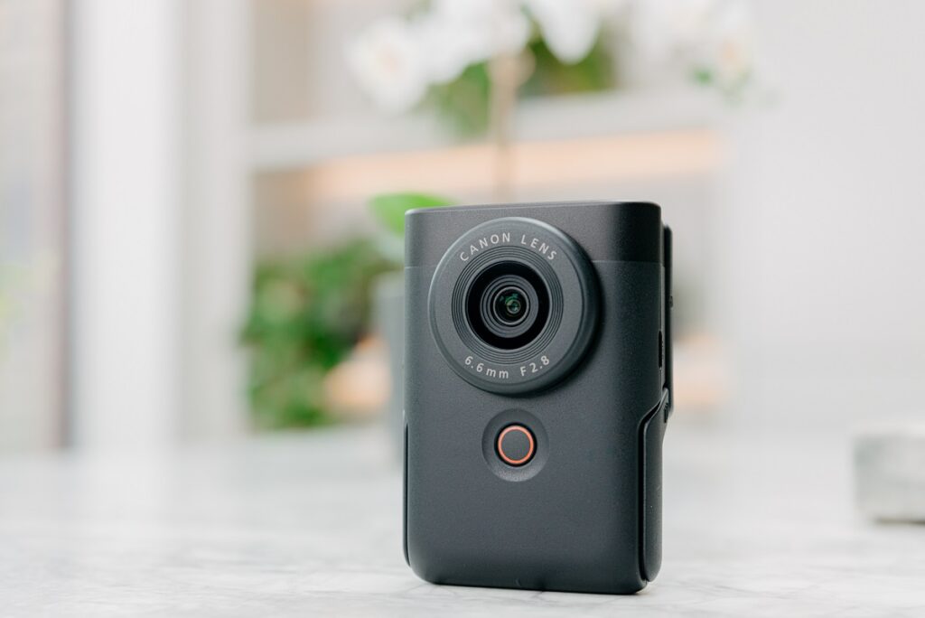 a closed silver Canon PowerShot V10  vlogging camera